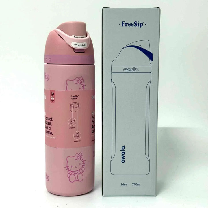 Pink Owala FreeSip water bottle with dual spout and Hello Kitty design next to its white packaging box.