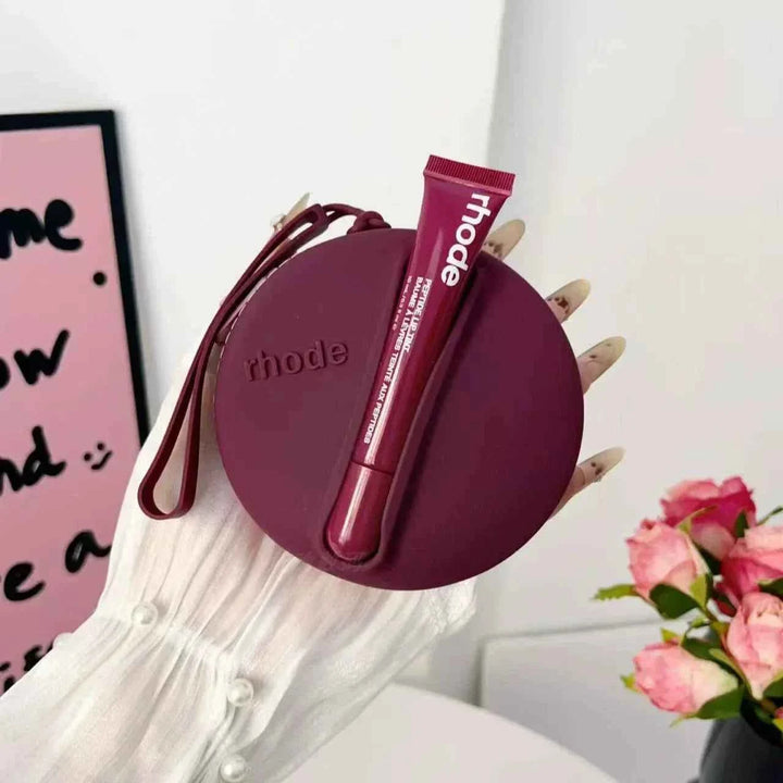 Rhode Peptide Lip Tint in deep berry shade with matching round silicone pouch for moisturizing and glossy lips