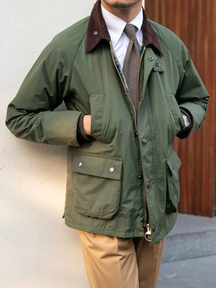 Mr. Lusan winter retro British jacket in olive with corduroy collar and front pockets worn with beige pants