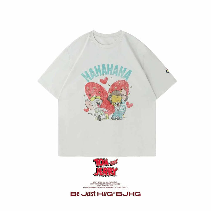 White oversized cotton T-shirt featuring a vintage-style Tom and Jerry graphic with playful "HAHAHAHA" text.