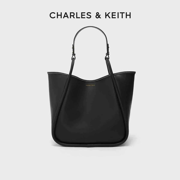 Large black CHARLES & KEITH shoulder bag made of premium faux leather with adjustable strap and spacious interior.