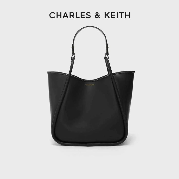 Large black CHARLES & KEITH shoulder bag made of premium faux leather with adjustable strap and spacious interior.
