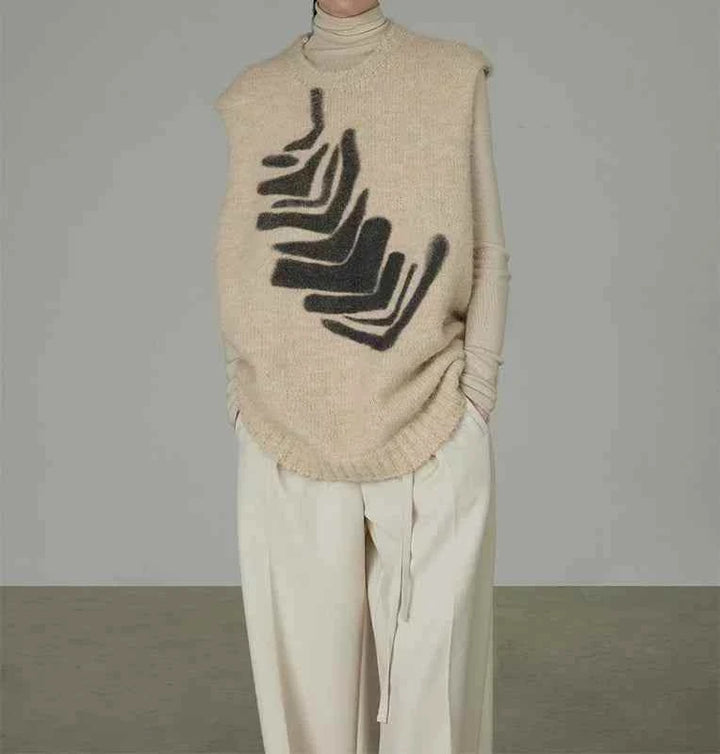 سترة محبوكة نسائي بدون أكمام بنقشة عصرية بلون بيج مع تفاصيل سوداء تصميم واسع مريح وأنيق