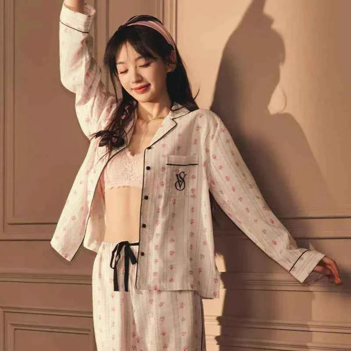 woman wearing Victoria's Secret star staycation Tencel soft print long sleeve pajama set in light pink with black details and headband