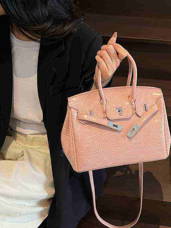 Elegant pink Birkin-style women's handbag with crocodile pattern and high-quality leather texture