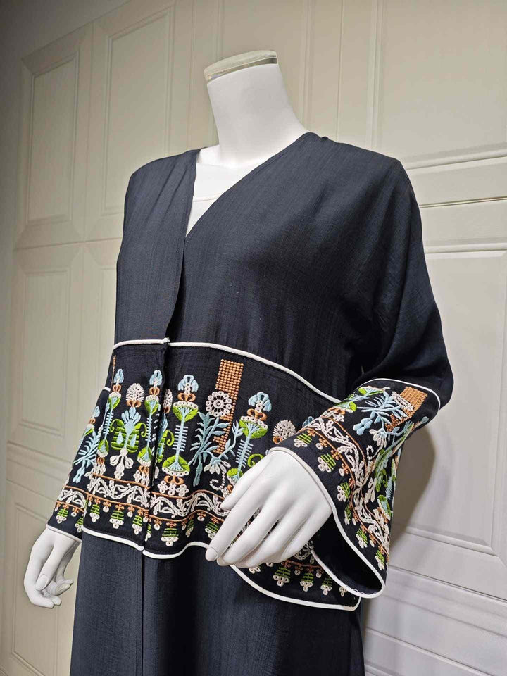 Elegant contemporary embroidered abaya with traditional motifs, loose fit, perfect for stylish occasions.