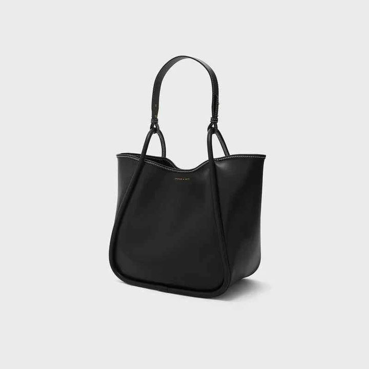 large black CHARLES & KEITH shoulder bag with adjustable strap and minimalist design