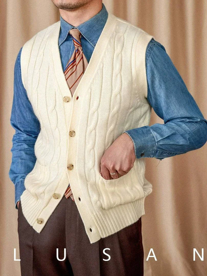 Mr. Lu San's wool cardigan vest in cream cable knit with pearl buttons and practical pockets, styled over a blue shirt and tie.