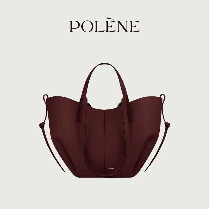 Polène Cyme Mini small tote bag in maroon leather with smooth curves, handmade in Spain.