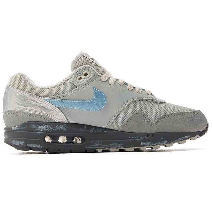 Nike Air Max 1 sneaker, classic modern design, gray and blue tones, featuring side logo and cushioned sole for comfort.