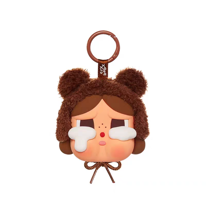 Crybaby figurine keychain with brown bear hat and large white tears, cute emotional cartoon design.