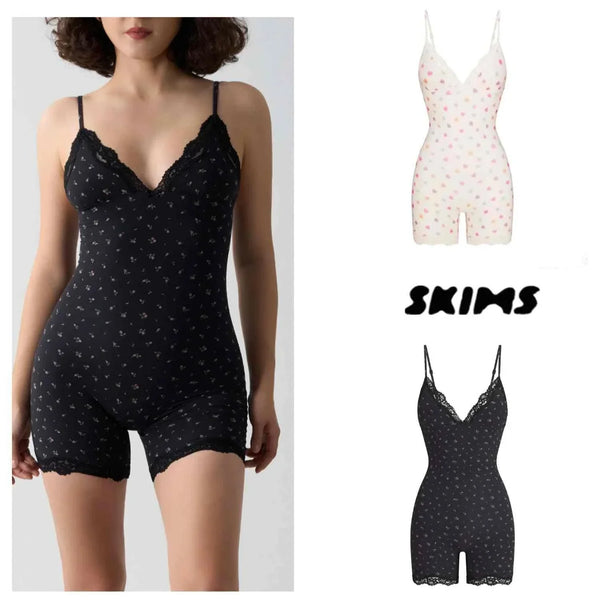 Soft laceSKIMS Kardashian bodysuit with delicate floral and heart prints in black and white, featuring adjustable straps and a comfortable, stretchy fit.