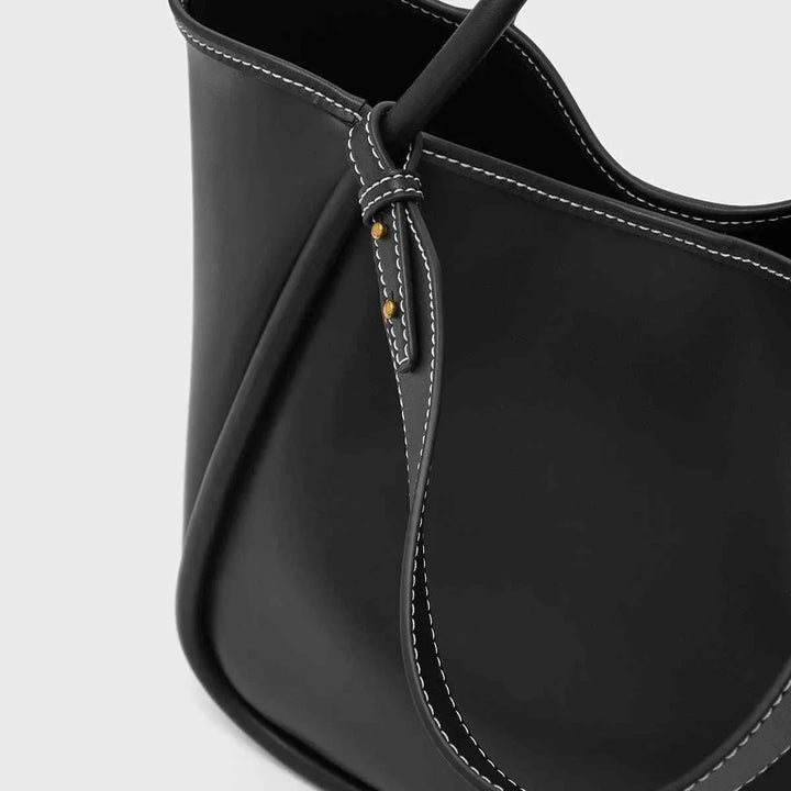 Black large Charles & Keith shoulder bag with white stitching and adjustable strap made of premium faux leather.