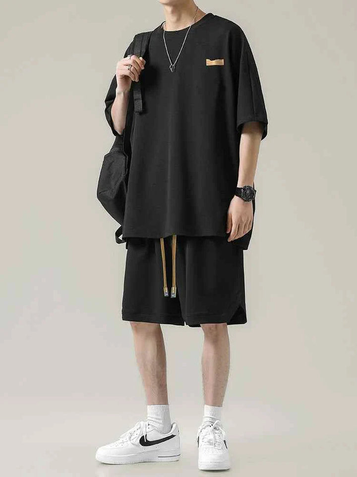 Men's Ice Silk set with loose black T-shirt and practical shorts, breathable and wrinkle-resistant fabric for summer comfort.