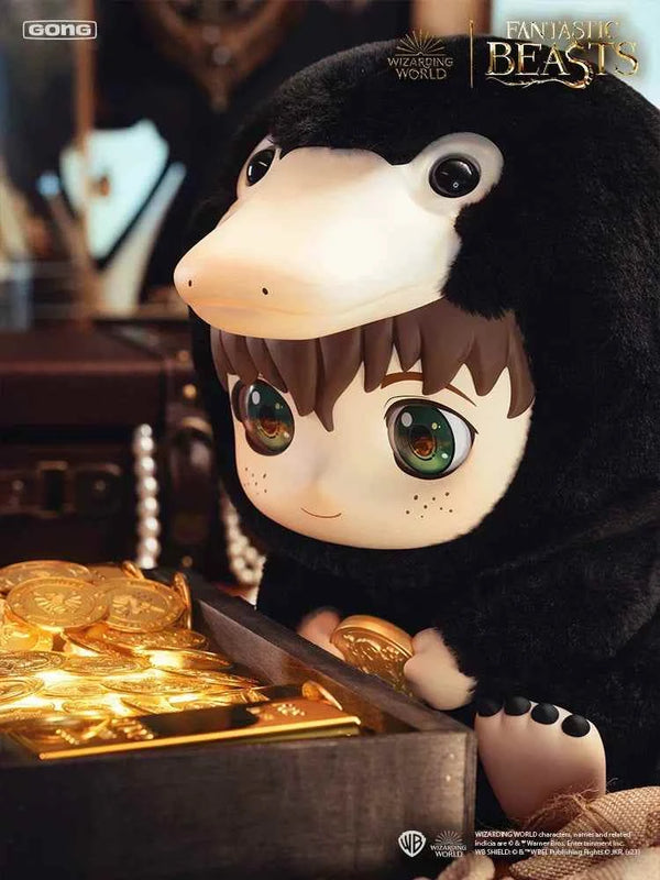 Harry Potter plushie dressed as a Niffler, surrounded by gold coins, from Fantastic Beasts series.