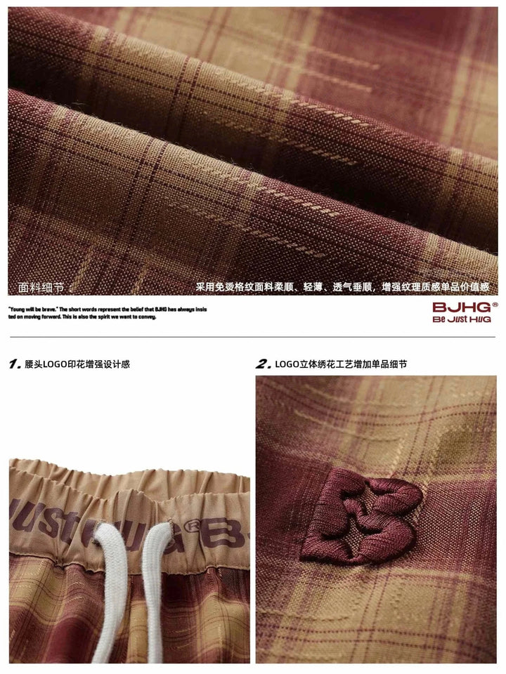 Wide checkered pants BJHG with classic plaid pattern and soft fabric in warm brown tones, featuring elastic waistband and logo details for casual comfort and stylish everyday wear.