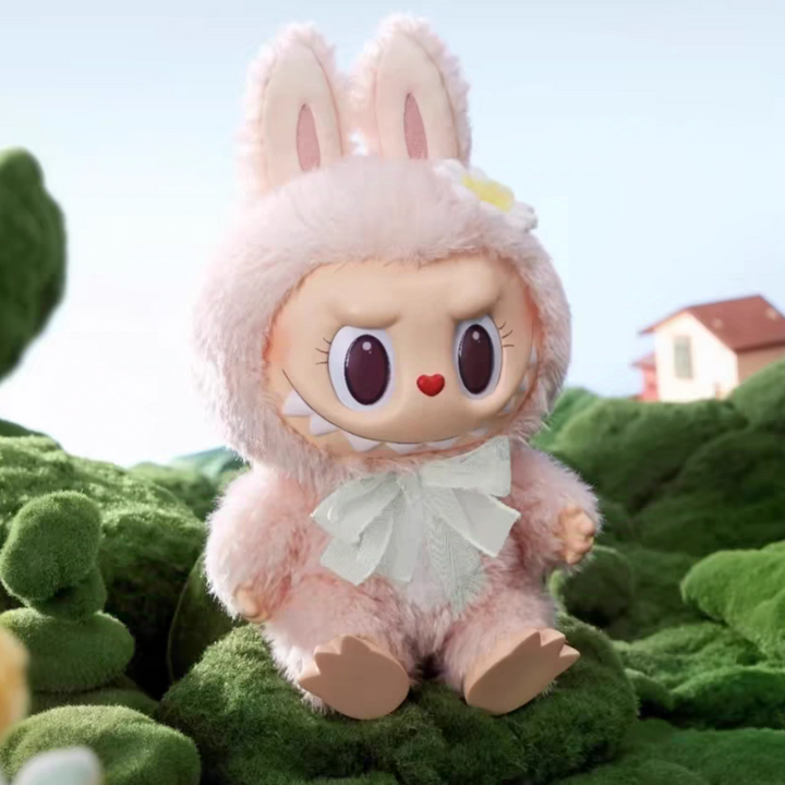 Pop Mart THE MONSTERS I FOUND YOU vinyl face doll in a fluffy brown bunny costume sitting on grass.