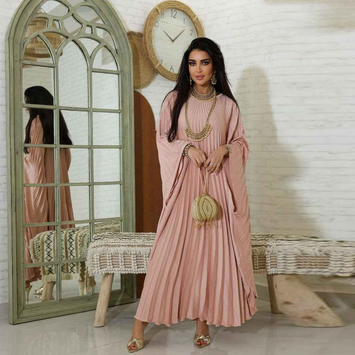 Elegant pleated dress with wide sleeves in soft pink, featuring a loose fit design.