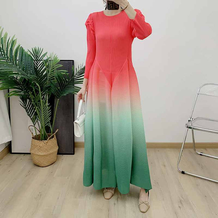 Long gradient dress with pleated sleeves and flowing design in multiple colors.