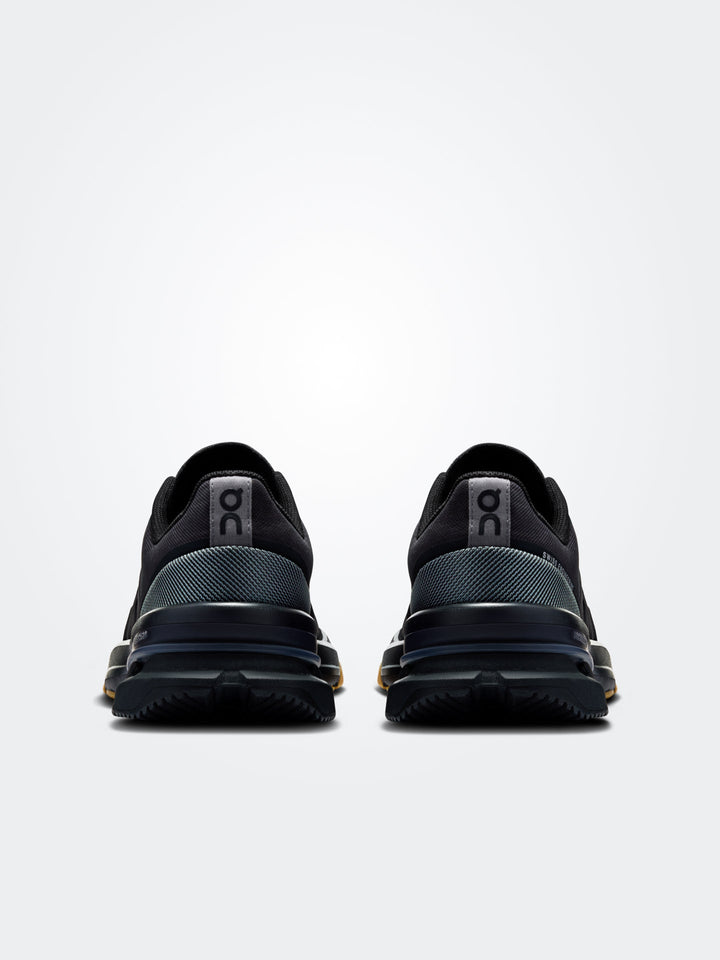 rear view of black On Run Cloudpulse Pro 2025 women's fitness training shoes against gray background