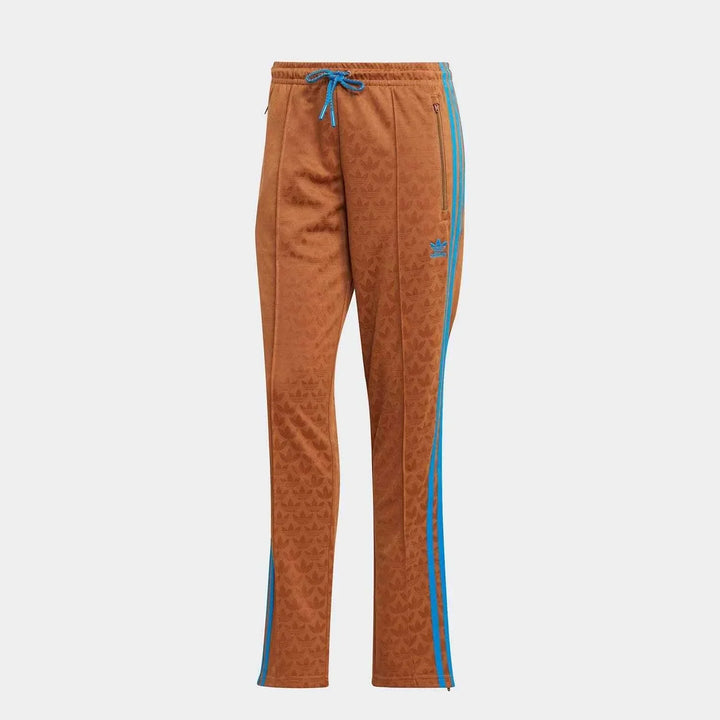 Brown Adidas pants with blue side stripes and adjustable waistband in a stylish patterned fabric