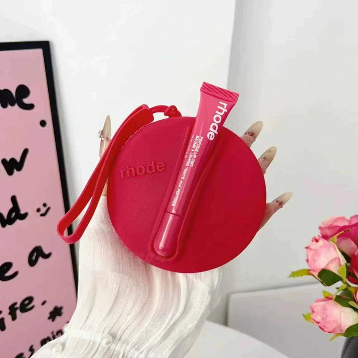 Rhode Peptide Lip Tint with matching red silicone pouch, nourishing lip tint in sleek tube, portable and stylish cosmetic accessory.