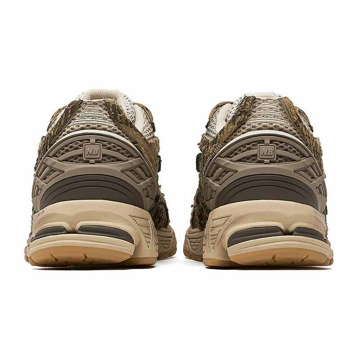 Rear view of New Balance 1906R PandaPrank Wasteland Limited Edition sneakers in earthy tones with mesh and leather materials.