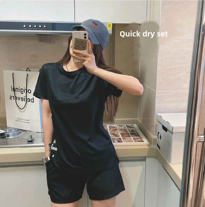 Quick-drying light oxygen exercise suit, women's black two-piece summer fitness set in kitchen setting.