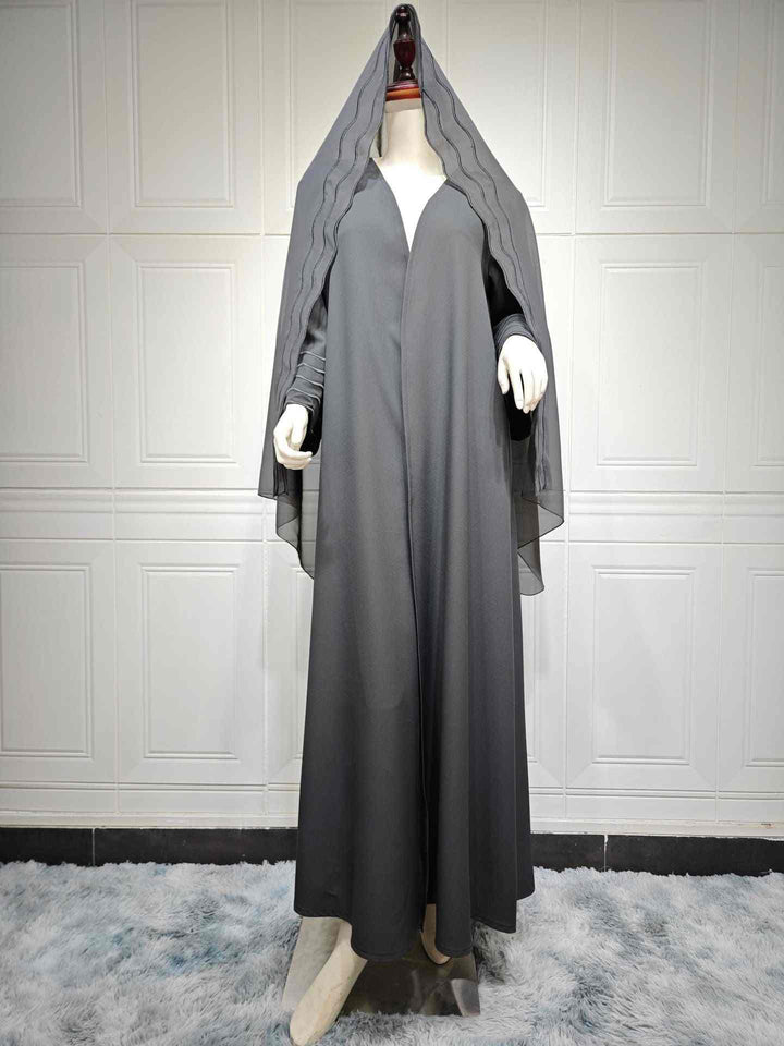 Exquisite modern abaya with elegant lines, luxurious fabric, matching hijab, and stylish wave details.