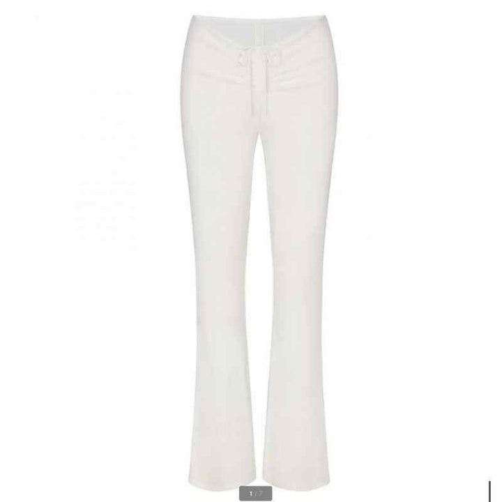 SKIMS wide leg lounge pants in white with adjustable waist tie for comfort and casual style