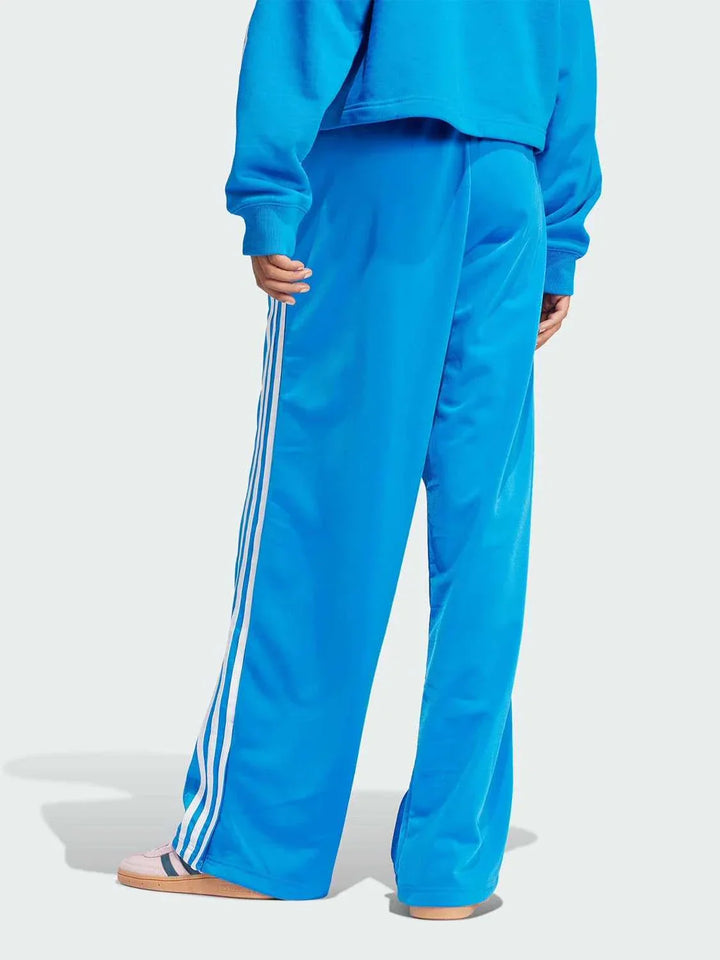 Blue Adidas sports pants with wide fit and classic white side stripes