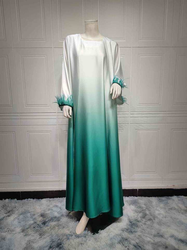 Elegant satin abaya with color gradient and feathered sleeves.