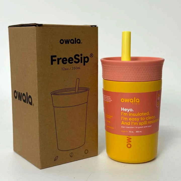 Yellow Owala FreeSip insulated spill-resistant water bottle with pink lid and straw next to its brown packaging box