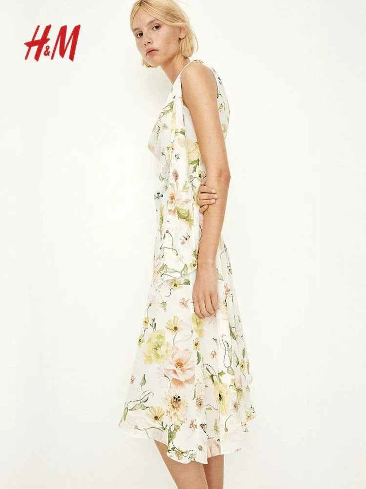H&M floral sleeveless midi dress with a round neckline and asymmetrical hem.