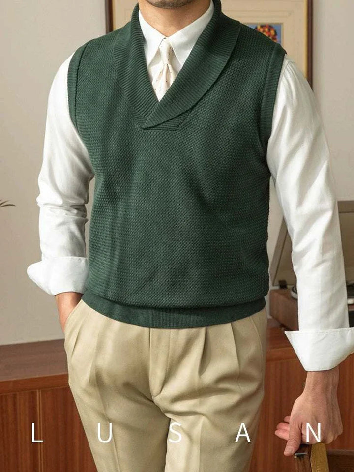 Mr. Lusan warm sweater vest in dark green with shawl collar and textured knit pattern worn over white shirt