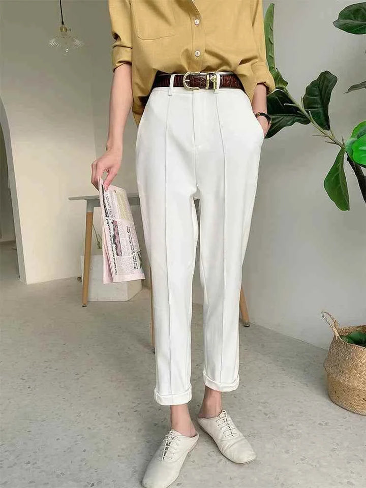 Elegant white formal pants with a classic comfortable cut for women, paired with a beige shirt and brown belt, styled for office or casual chic looks