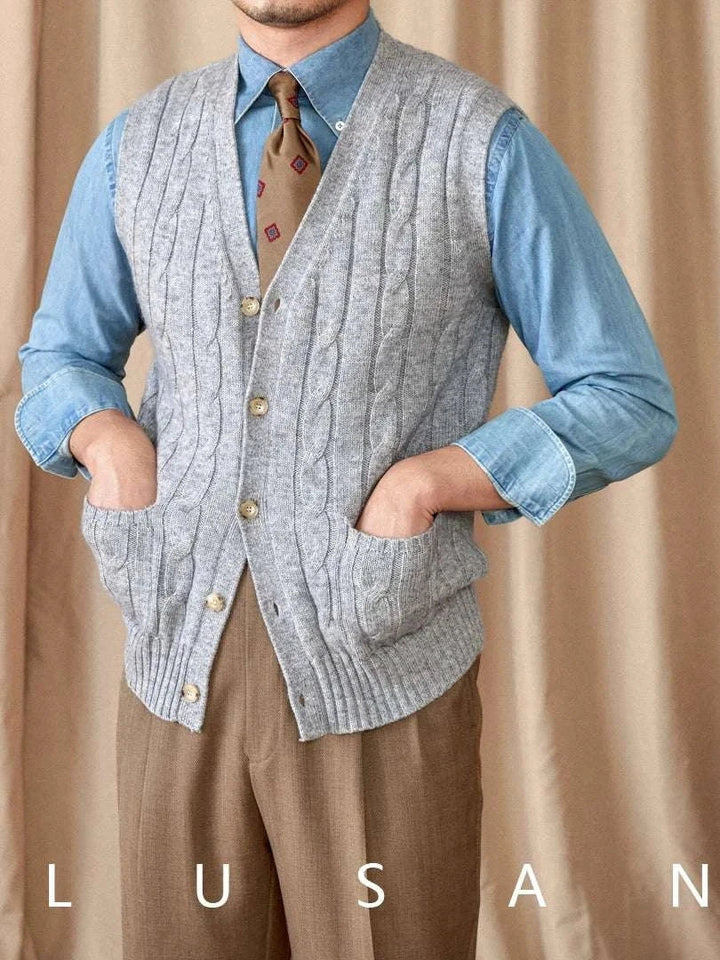 Mr. Lu San's wool cardigan vest in gray with cable knit and pearl buttons worn over blue shirt