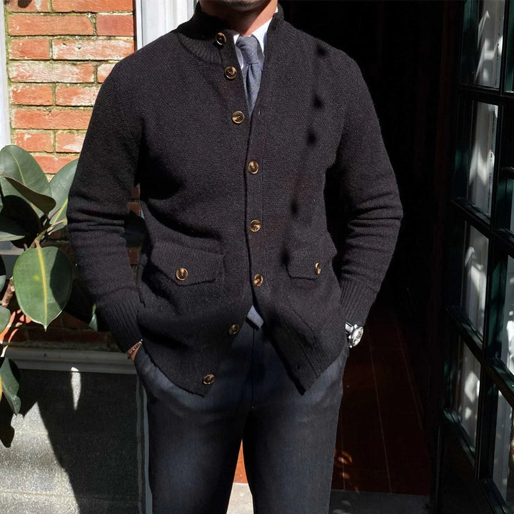 Mr. Lu San cardigan in black with ribbed sleeves, brown buttons, and front pockets, styled in a formal outfit