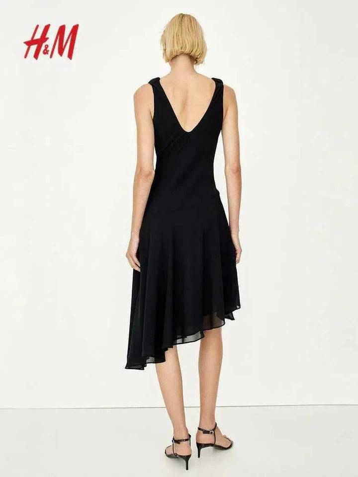 H&M knee-length black sleeveless dress with wide neckline and asymmetrical hem.
