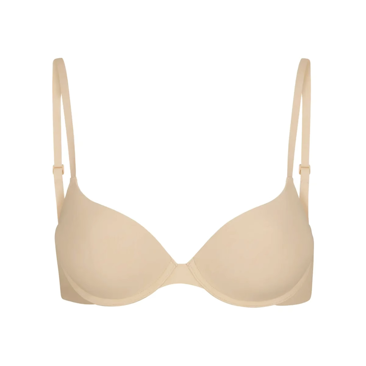 Soft supportive multi-color SKIMS bra with seamless design and adjustable straps in beige tone