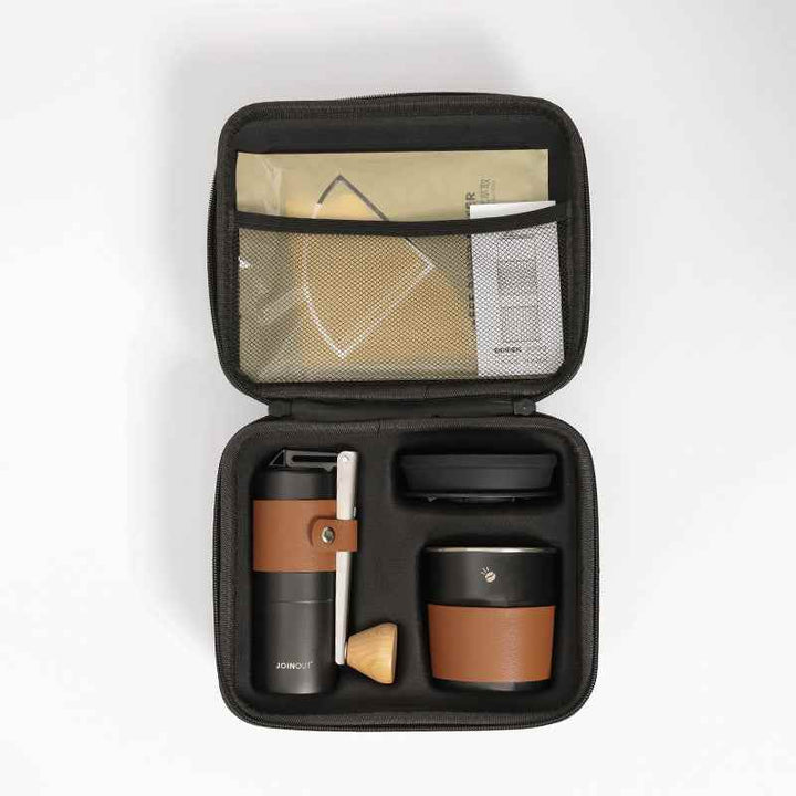 Portable coffee brewing kit with a grinder, V60 filter, and travel cup in a compact case.