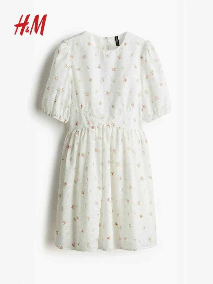 HM embroidered backless dress with puff sleeves and floral pattern.اتش اند ام