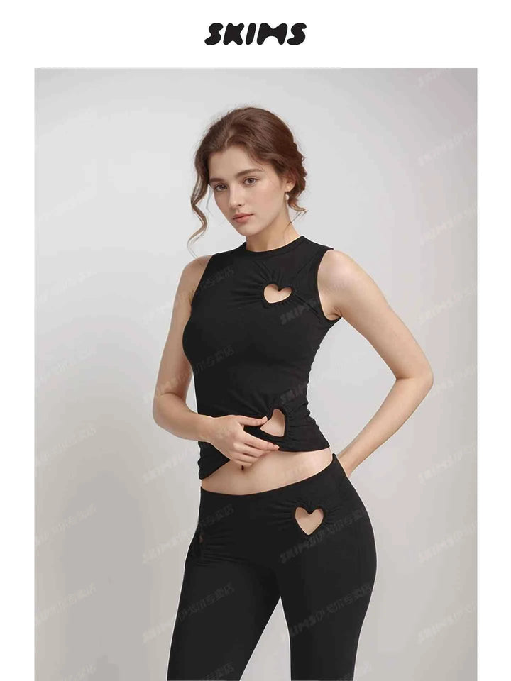 Black SKIMS Kardashian women's tank top and leggings with heart-shaped cutouts, trendy and fitted design.
