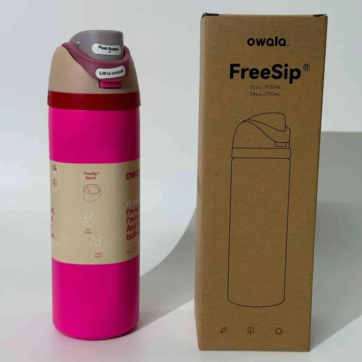 Owala Thermos CupKitty Limited Edition pink stainless steel insulated water bottle with FreeSip dual spout and spill-proof lid next to its cardboard packaging box
