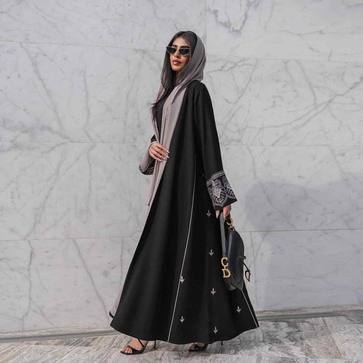 Elegant black abaya with embroidered sleeves and gold details, perfect for formal and casual occasions.