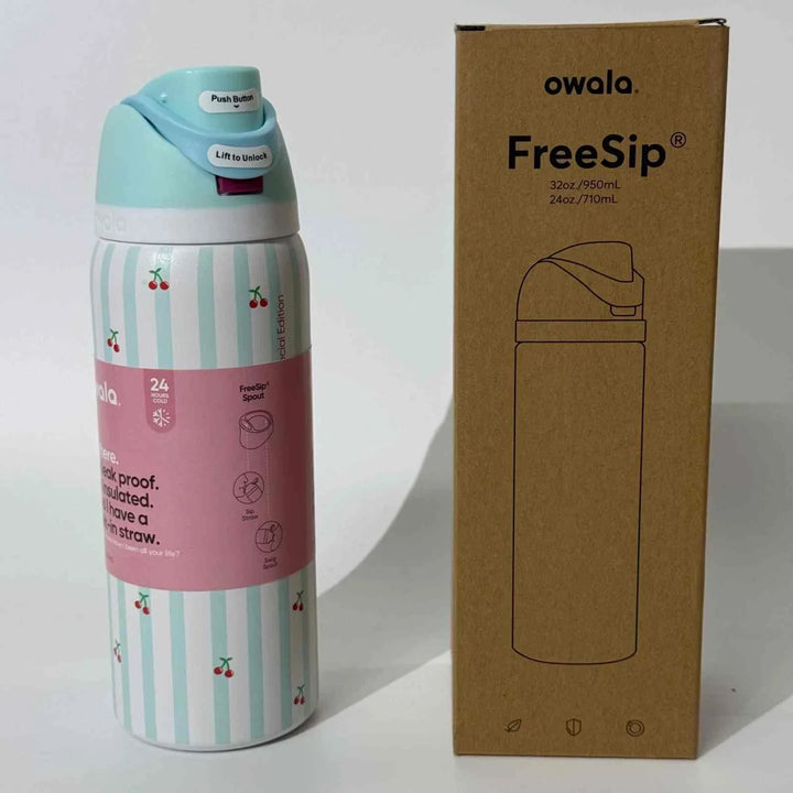 Owala Thermos CupKitty Limited Edition stainless steel insulated water bottle with cherry design and leak-proof FreeSip lid next to its packaging box
