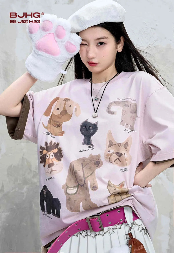 Casual cartoon animal print T-shirt in light pink, featuring playful and colorful animal illustrations.