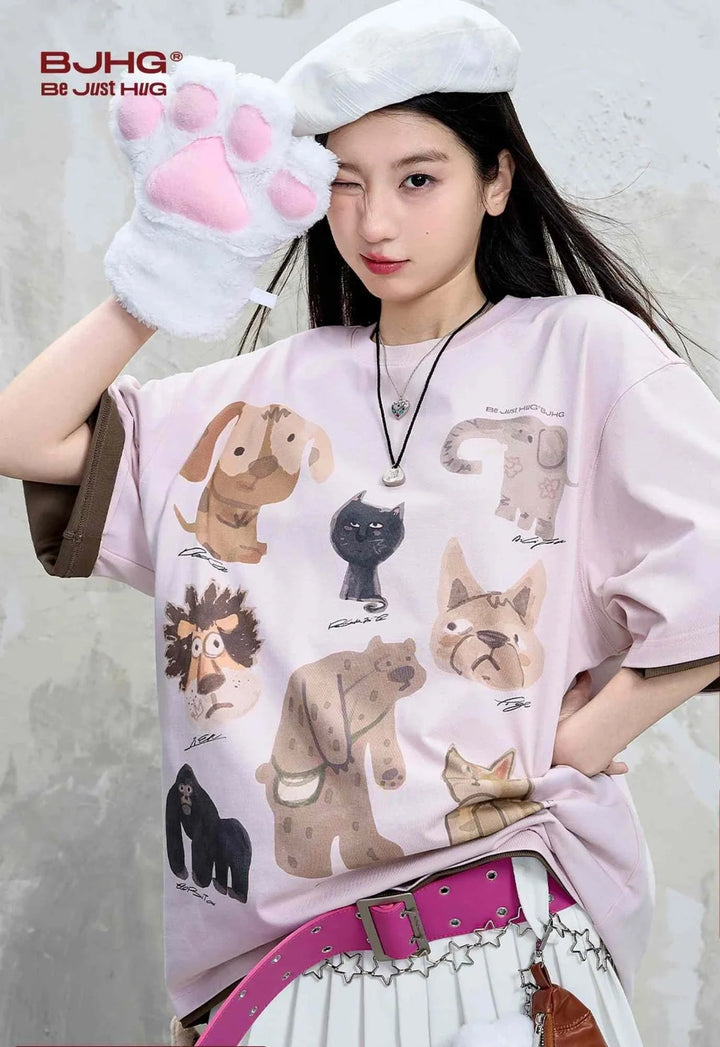 Casual cartoon animal print T-shirt in light pink, featuring playful and colorful animal illustrations.