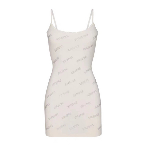 White Skims short dress with slender straps and subtle logo print, designed for comfort and style.