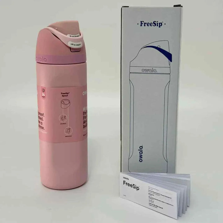 Pink Owala FreeSip stainless steel water bottle with dual drinking spout and leak-proof design alongside its packaging and user manual.